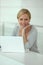 Blond woman in front of computer