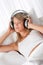 Blond woman with headphones listening to music