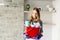 Blond woman holding a bucket full of cleaners