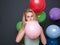 Blond woman inflating balloons for a party