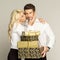 Blond woman kissing handsome man with gifts