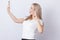 Blond woman making selfie on mobile phone