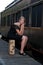 Blond woman near an old train