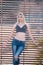 blond woman with perfect flat stomach lean on partition walls