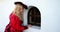 Blond woman in red historic costume old fashioned looking in the secret window