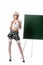 blond woman in seductive school uniform eyeglasses and stockings standing at empty chalkboard