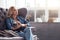 Blond woman sitting with cat on couch.