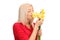 Blond woman smelling a bunch of tulips