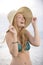 Blond woman with sunhat on the beach