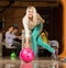 Blond woman throwing bowling ball