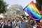 Blond youth with peace flag at Pride Parade TA