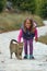 Blonde 4 year old girl caresses a kitten