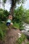 Blonde attractive female swings from a rope tree swing in Wyoming