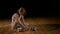 Blonde ballerina untying shoes and sitting on a floor tired
