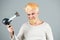 Blonde bearded man hair dry. Young man drying hair with hairdryer.