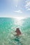 Blonde bikini woman swimming tropical ocean