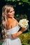 a blonde bride with bouquet Calla Lily in a white dress. wedding fashion