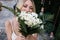 Blonde bride covering face with blurred