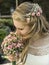 Blonde bride inhale smell aroma of a flower bouquet from roses holding during wedding marriage