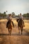 Blonde and brunette ride on dirt track