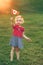 Blonde Caucasian baby toddler girl holding waving Canadian flag.