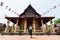 Blonde Caucasian woman making selfie in front of Wat Sisaket in Vientiane, Laos