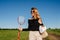 Blonde in countryside on a track in the middle of nowhere with a bag for picnic