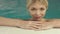 Blonde cute woman enjoying water in swimming pool