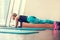 Blonde female doing plank static exercise in gym