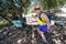 Blonde female hiker points the way to the Potato Chip Rock trail in Southern California, in the Mt. Woodson area near San Diego