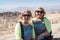 Blonde females mother and daughter pose for a photo at scenic overlook - Zabriskie Point in Death Valley National Park