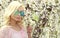 Blonde Girl with Aviator Sunglasses over Cherry Blossom. Spring