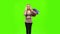 Blonde girl carries a multi colored packages, talking on the phone and smiles sweetly. Green screen