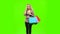 Blonde girl carries a multi colored packages, talking on the phone and smiles sweetly. Green screen