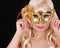 Blonde girl with gold carnival mask over black background. Masquerade