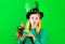 Blonde girl in Green hat with pot with gold and sending kiss. Saint Patricks day. Irish Traditions.