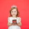 Blonde girl holding little cake and candle