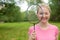 Blonde girl holding tennis -racket wearing pinck t-shirt