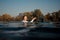 Blonde girl holding a wakeboard in the river