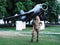 Blonde girl in military uniform staying near big plane looking at the camera full size