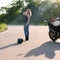 Blonde girl near modern motorcycle.