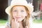 Blonde girl outside pretty beauty child with sunlight on her hair hat