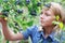 Blonde Girl Picking Blueberries