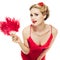 Blonde girl pin-up in red lace dress with fan in her hand leaned over and looks playfully at camera isolated on white background