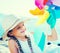 Blonde girl with Pinwheel on beach of sea