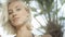 blonde girl posing on tropical beach.