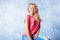 Blonde girl smiling and sitting with rugged jeans and messy hair