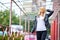 Blonde girl stands at the station with a suitcase pink