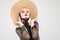 Blonde Girl in Transparent Blouse Enjoying Straw Hat