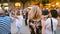 Blonde girl walks through the dancing crowd Barcelona Spain. Summer evening. Festivities. Editorial video footage